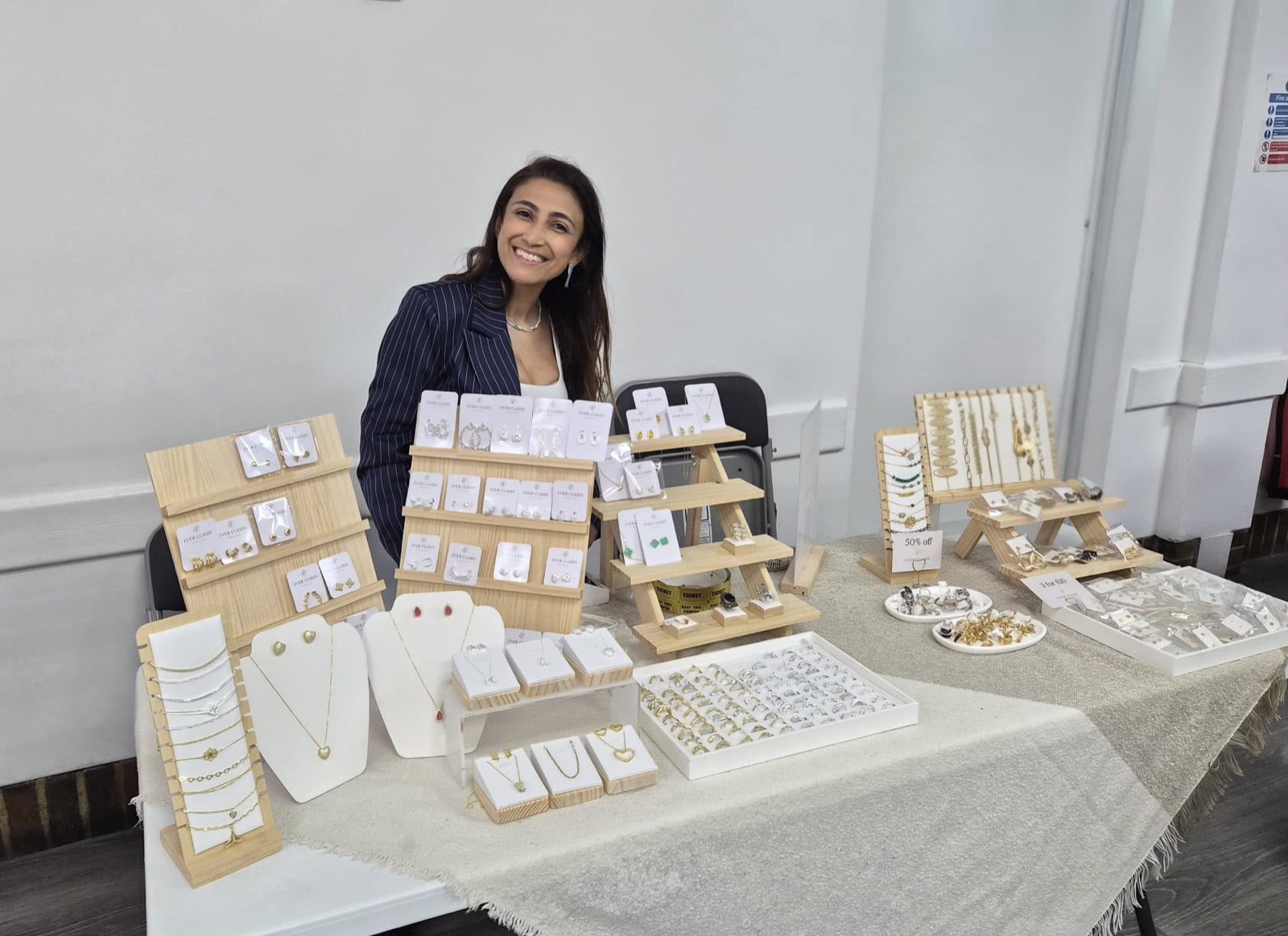 Smiling exhibitor behind her jewellery display